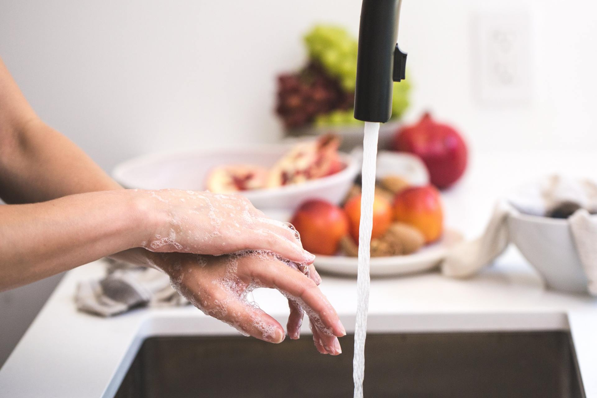 Person Washing Hands In A Unblocked Sink