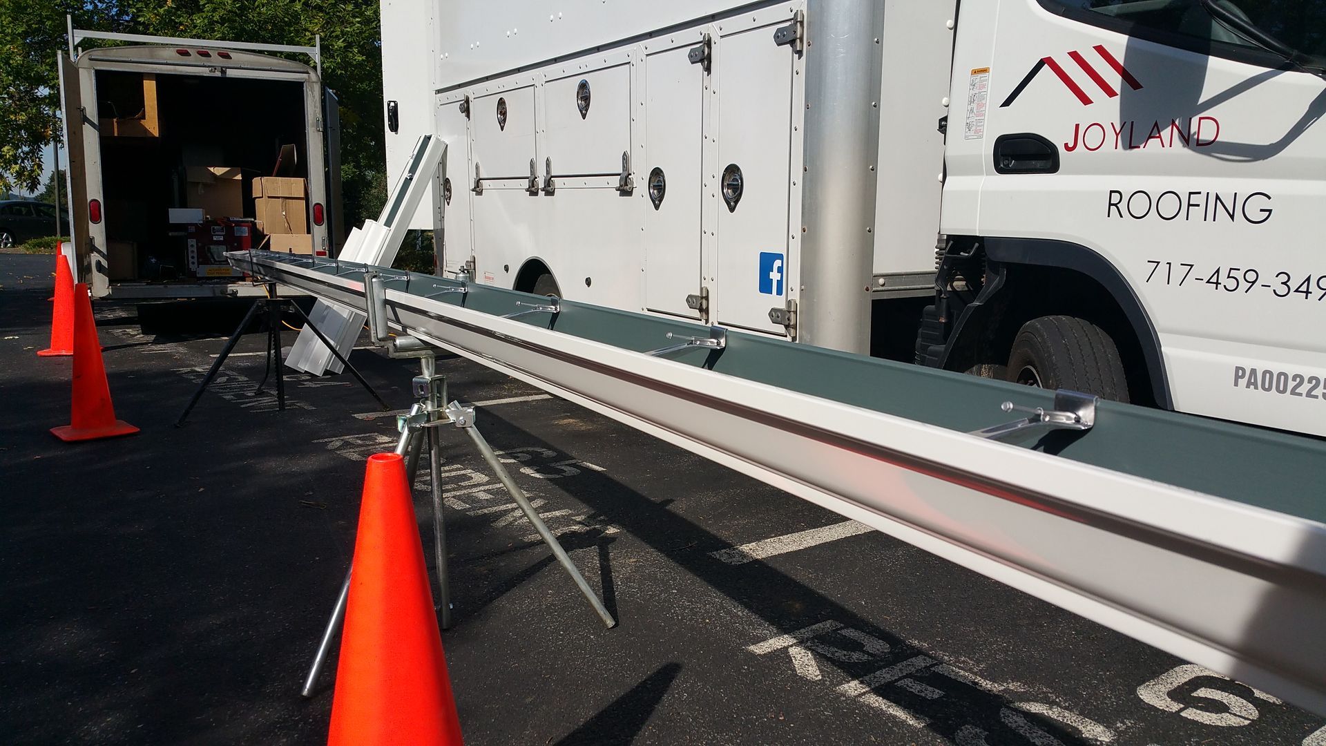 Close-up of wooden shake roof (left) and gray slate tile roof (right).