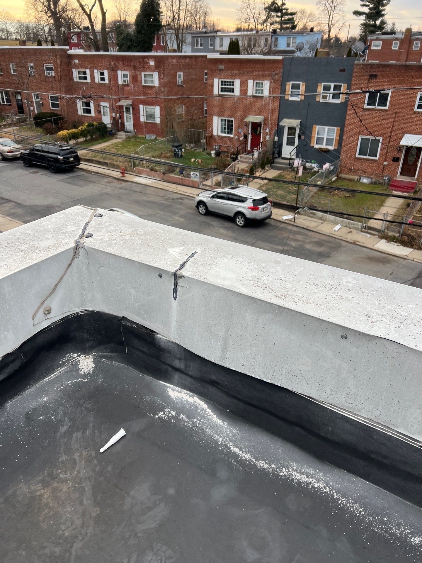 White pipe vent protruding from a gray shingled roof.