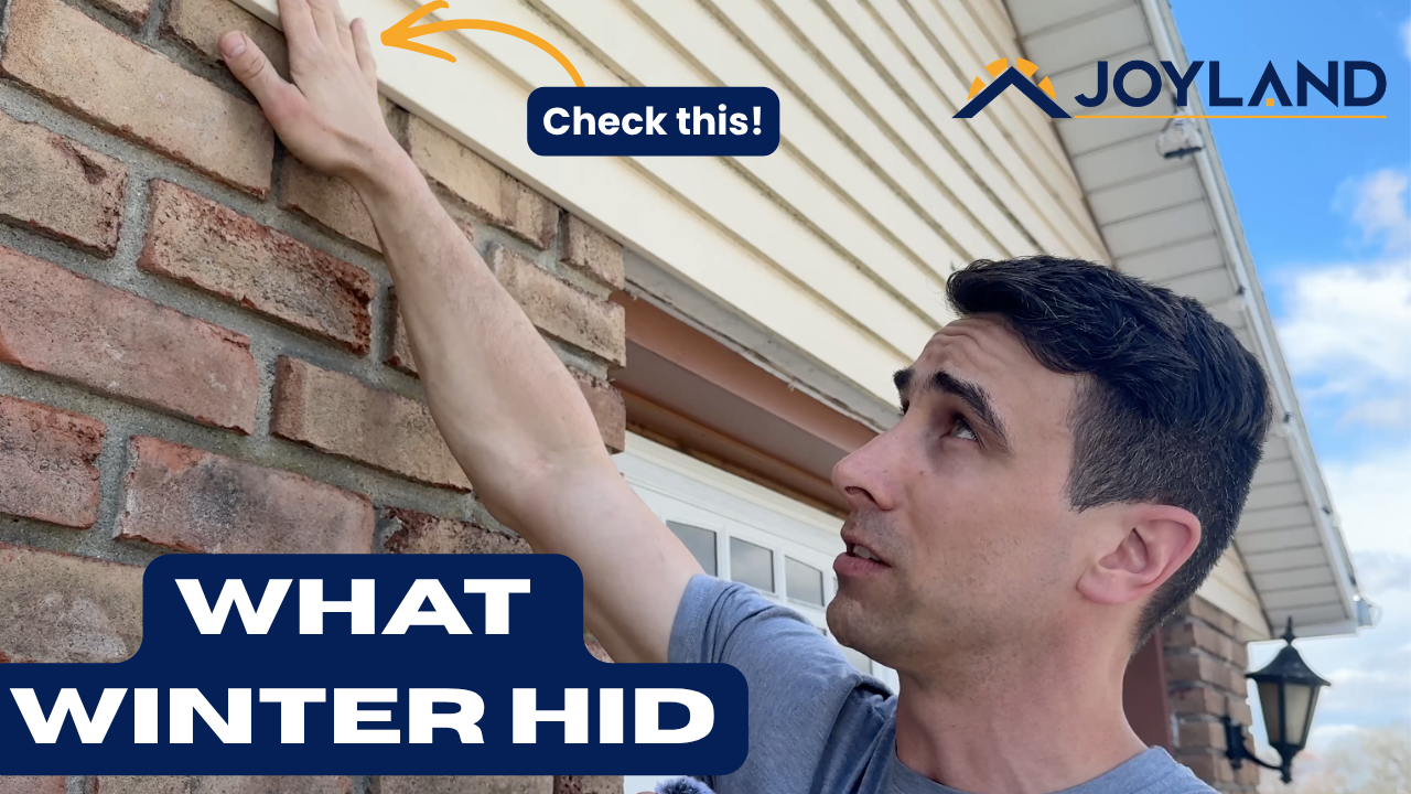 A person gestures toward a gap between brick and siding on a house exterior under the text 
