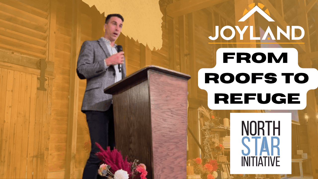 Man speaking at a podium, text reads