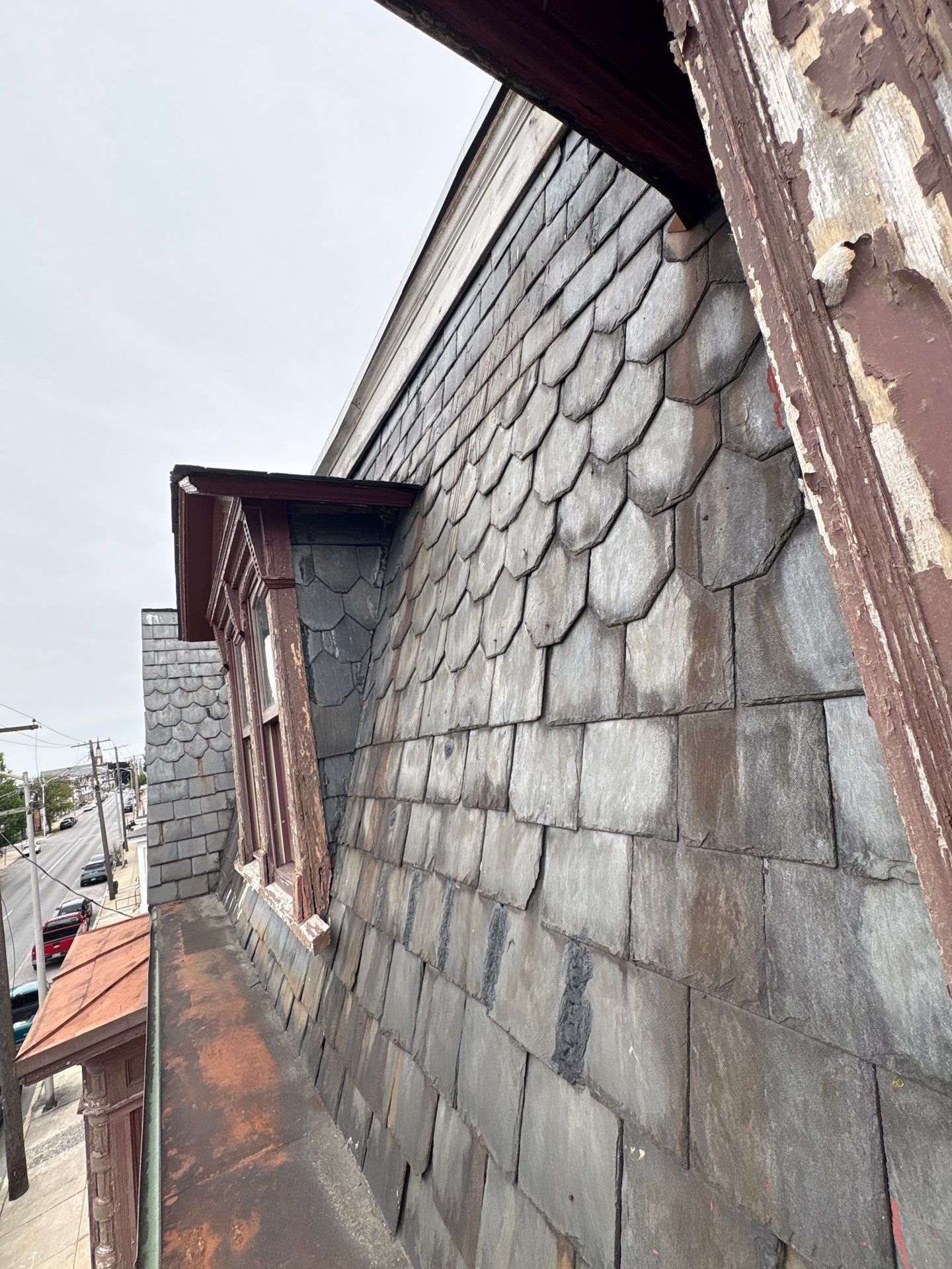 Close-up view of worn and uneven asphalt shingles on a residential roof in York, PA, showing signs of aging and weather-related roofing damage inspected by Joyland Roofing.