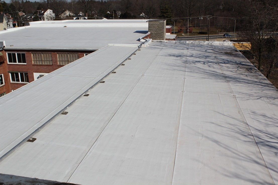 Wooden floor with a large, damaged square hole revealing a dark void.