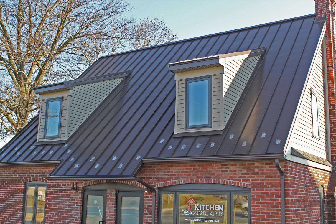 Damaged asphalt roof shingles with exposed wood underneath; multi-colored and weathered.