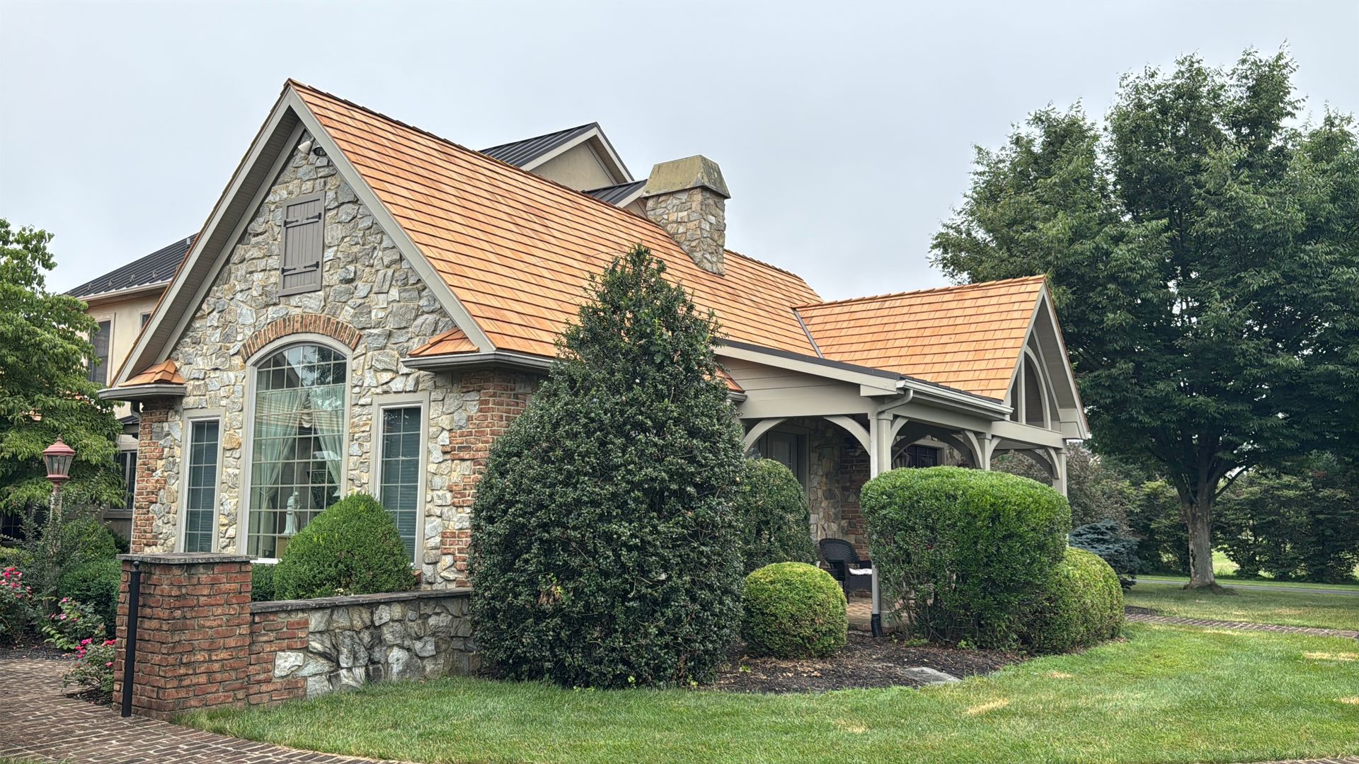 The photo describes a York County residence. the front of a home withh a brand new cedar shake roof done by Joyland Roofing