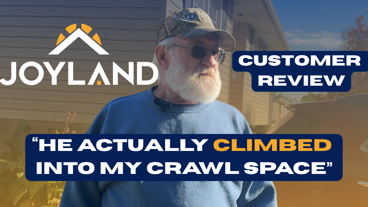 Man in cap and sunglasses in front of a home, with 