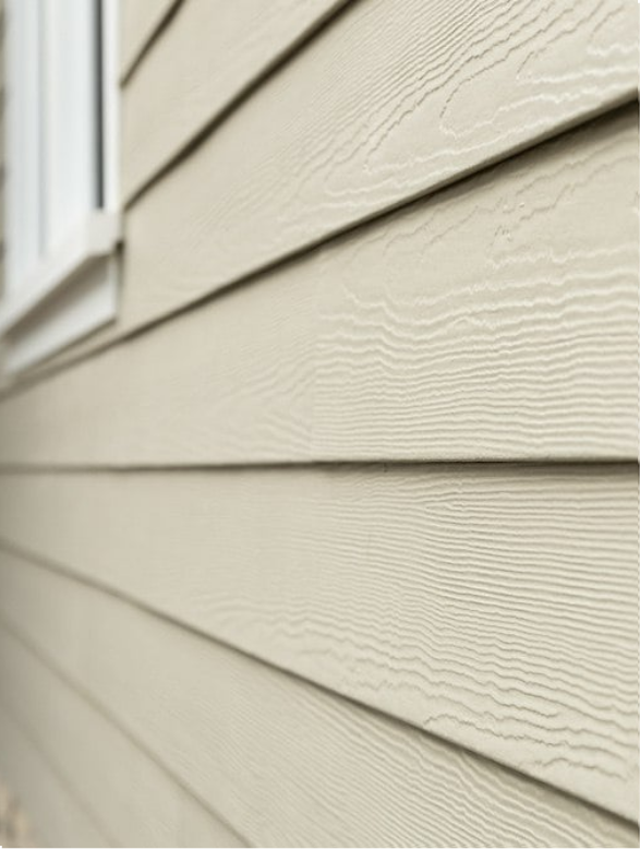 House siding partially removed, revealing plywood. A-frame roofline with ladder.