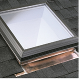 Skylight installed on a shingled roof, featuring a copper flashing and black frame.