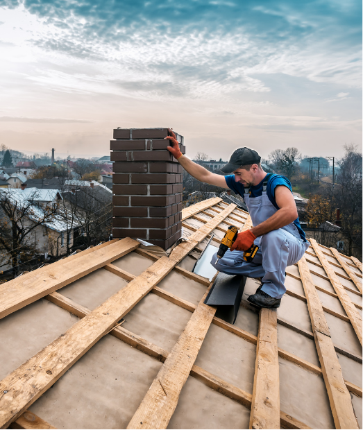 Roofer working on a roof, near a brick chimney. Wooden rafters visible; cloudy sky overhead.