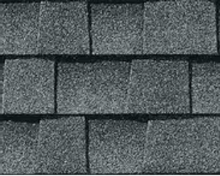 Gray asphalt shingles on a roof, overlapping in rows.