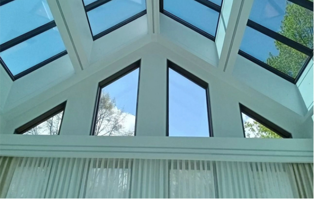 Orange stucco home with red tile roof against a blue sky.