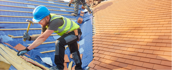 Person installing asphalt roof shingles outdoors.