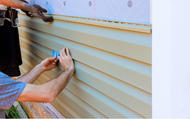 Two-story brick house with gray tiled roof and climbing ivy.