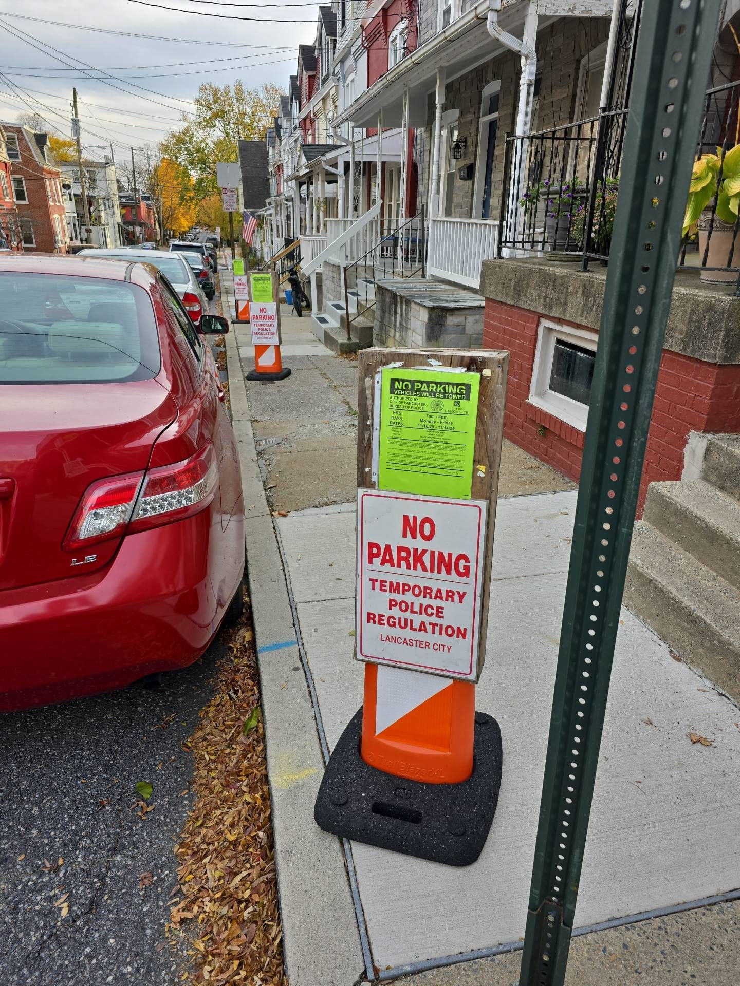 Red car parked next to sidewalk with