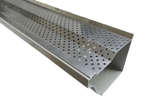 Perforated metal gutter guard, angled, with numerous small holes for debris filtration.
