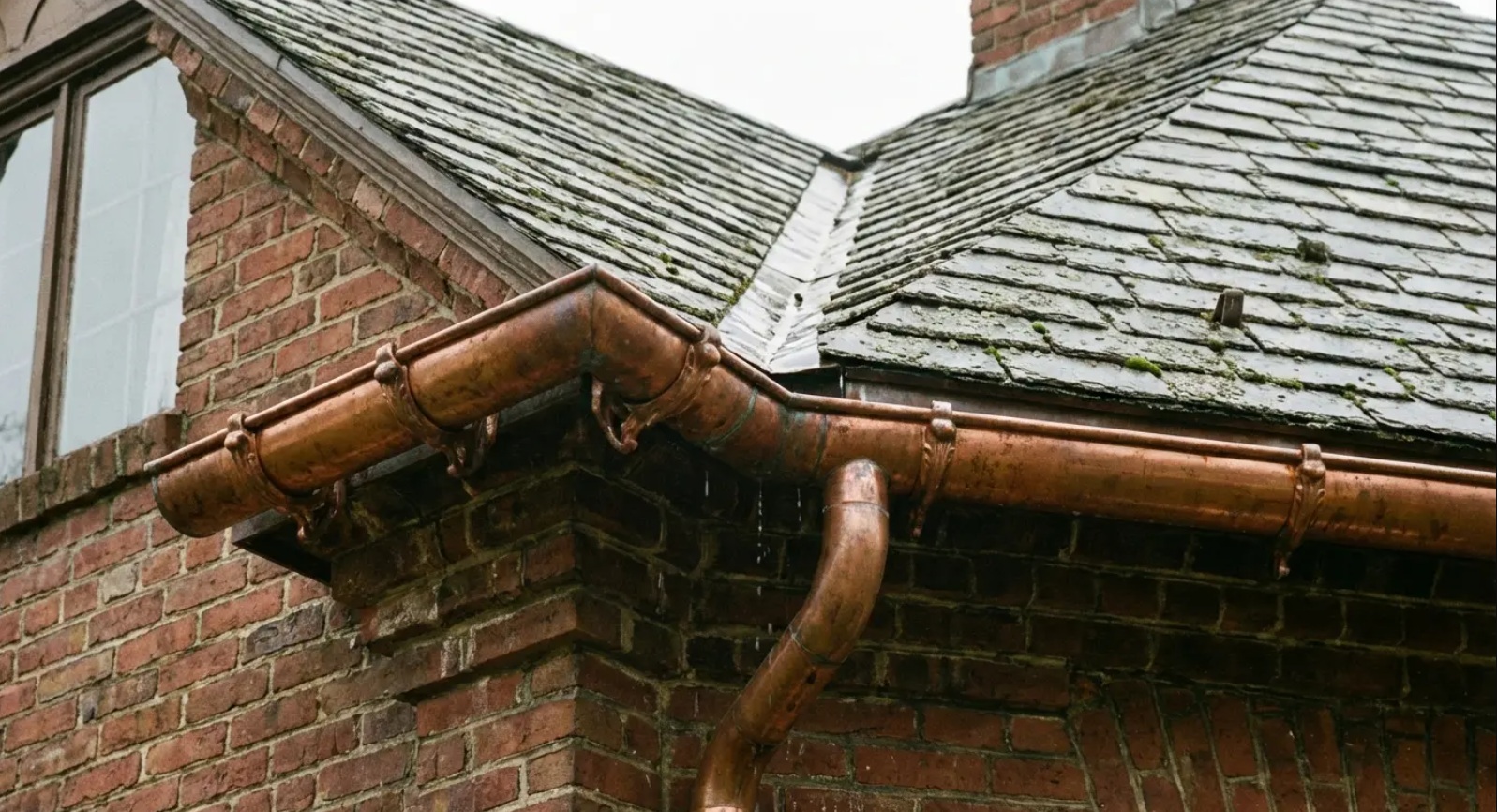 Copper half-round gutters on a home, showing the difference from K-style vs. half-round gutters.