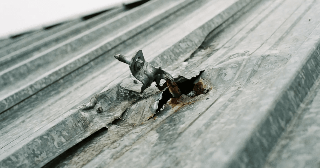 Metal roof damage and fastener failure caused by heavy snow loads without snow guards protection