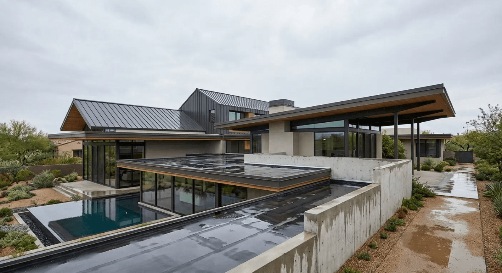 Contemporary home with flat and low-slope metal roof planes - bold design that trades water-shedding efficiency for aesthetics