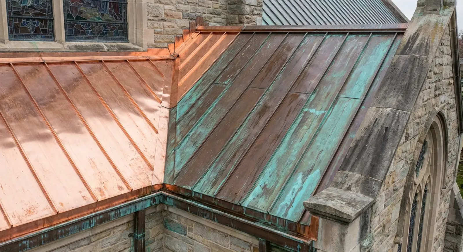 Copper church roof with areas of oxidation and new copper.