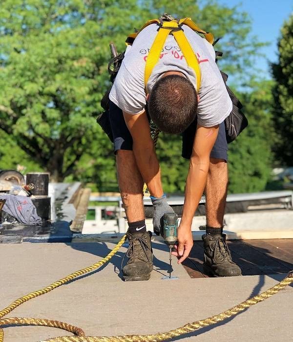 Wooden shingle roof with copper flashing and a gutter, partially visible.