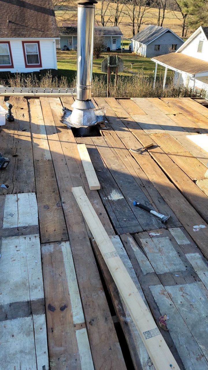 Roof decking replacement and chimney flashing repair in progress during a roofing project on Thompson Avenue in Jonestown, PA.