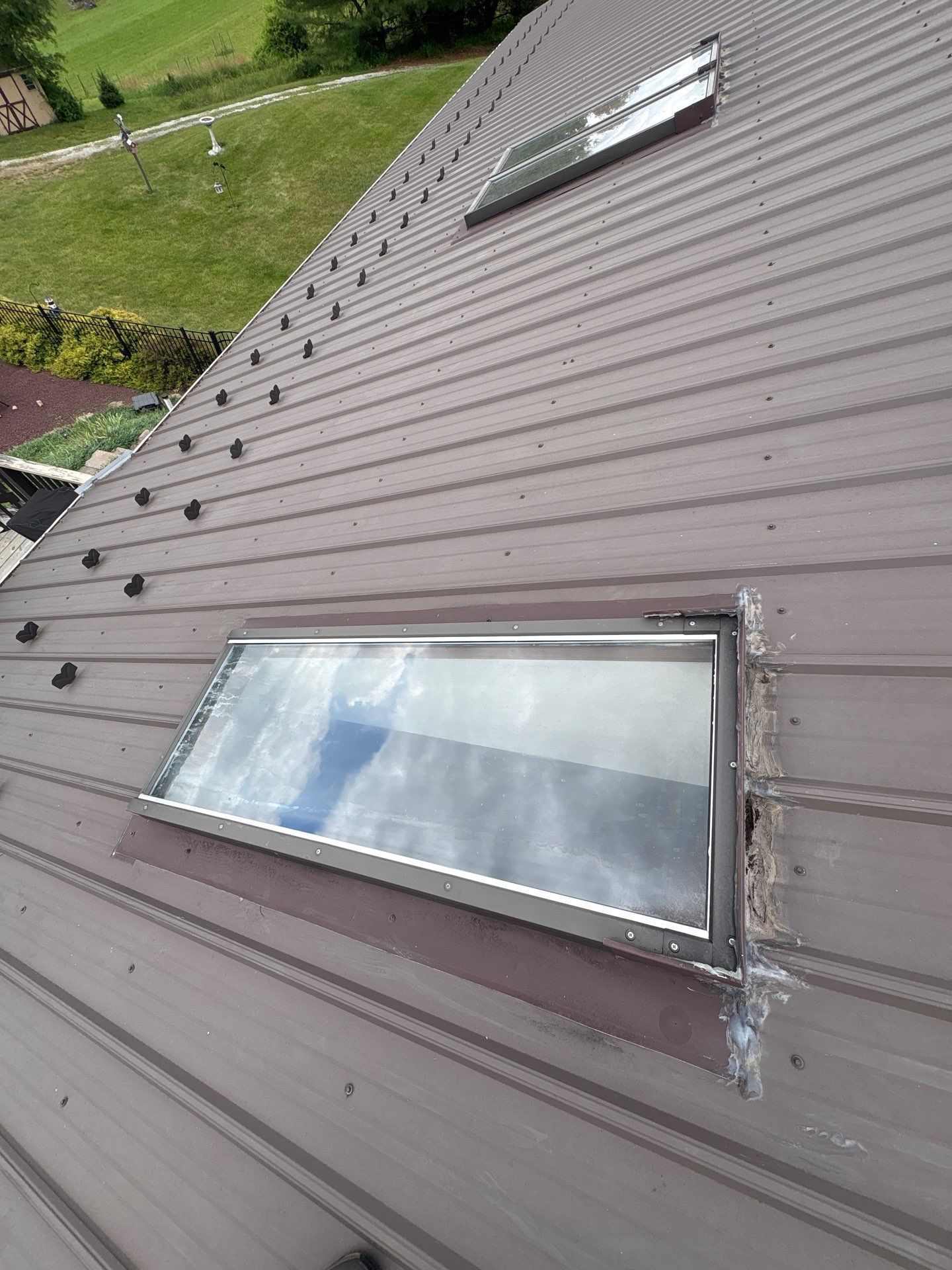 Metal roof skylight repair and resealing project on Moonshine Road in Jonestown, PA.