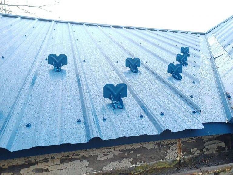 Blue metal roof with dark blue brackets attached.