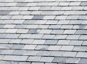 Close-up of a gray slate roof with diamond-shaped tiles.