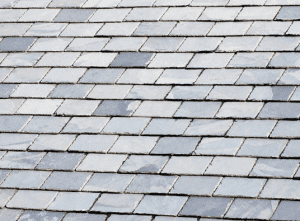 Gray and blue slate roof tiles arranged in a staggered pattern.