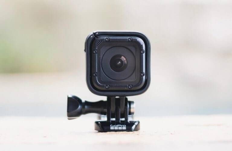 Black GoPro camera, front view, mounted on a black bracket.