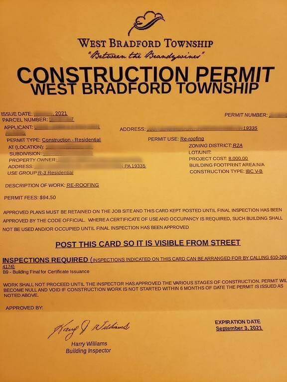 Construction permit from West Bradford Township, yellow card with text.