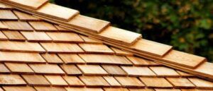 Close-up of a wooden shingle roof with staggered, diamond-shaped tiles.