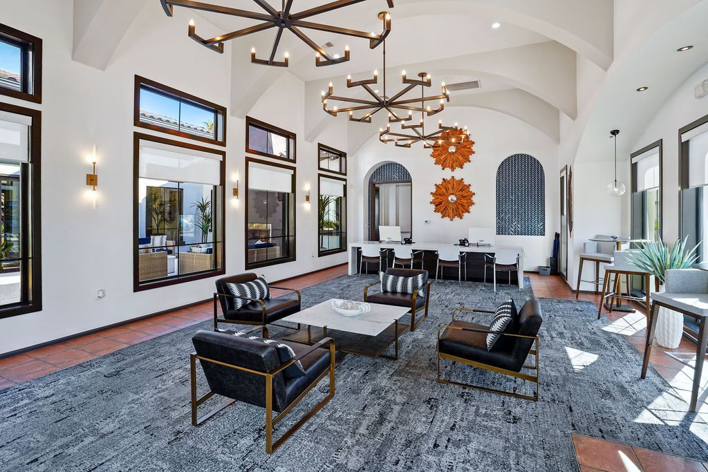 Spacious modern lobby with seating area, large windows, and high ceilings.