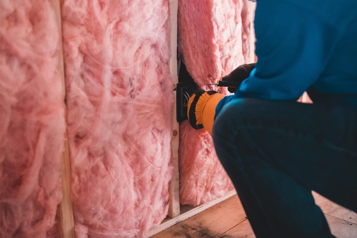 Adding pink insulation to a wall in Denver, CO