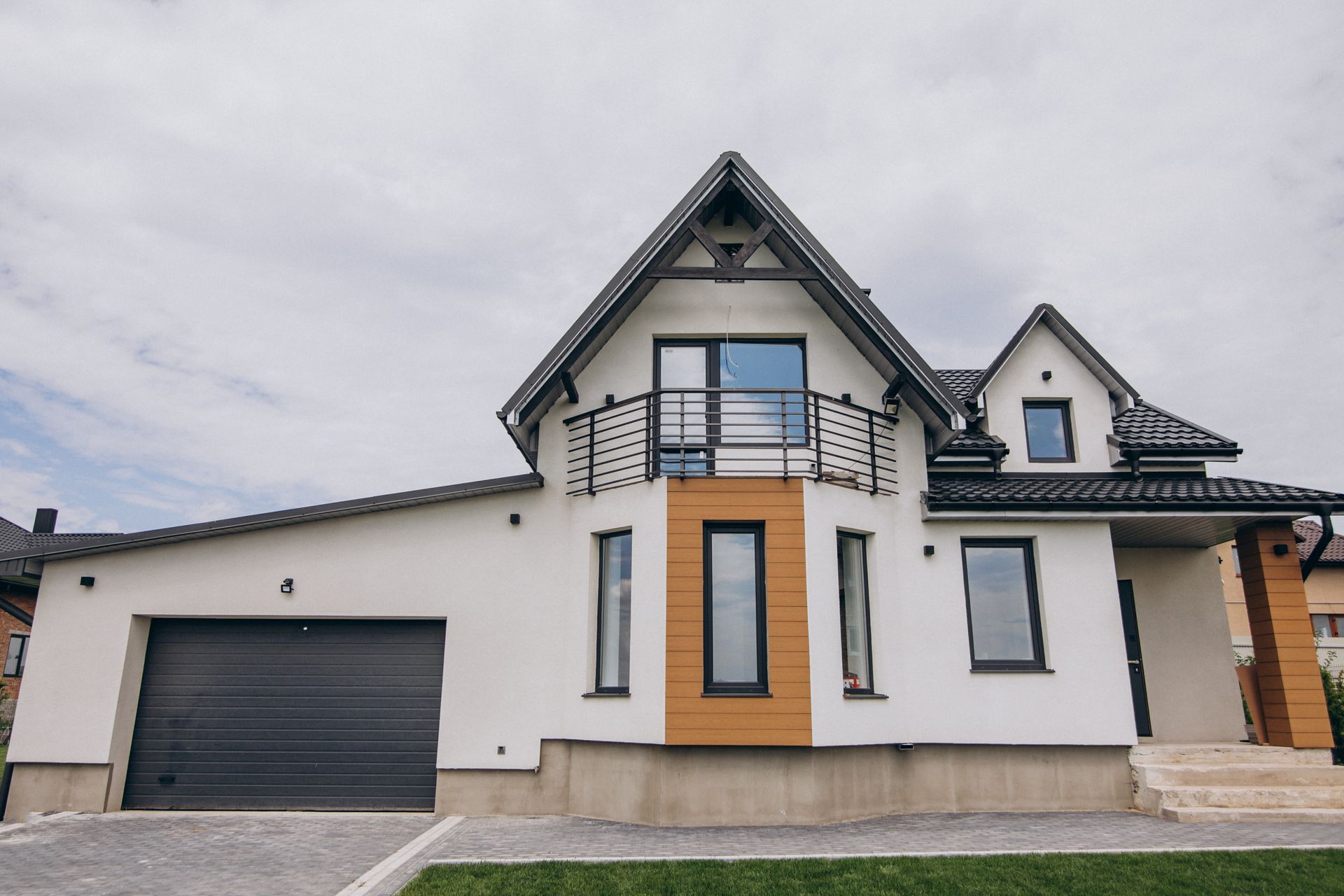 Person in protective suit spraying foam insulation into a wall frame.
