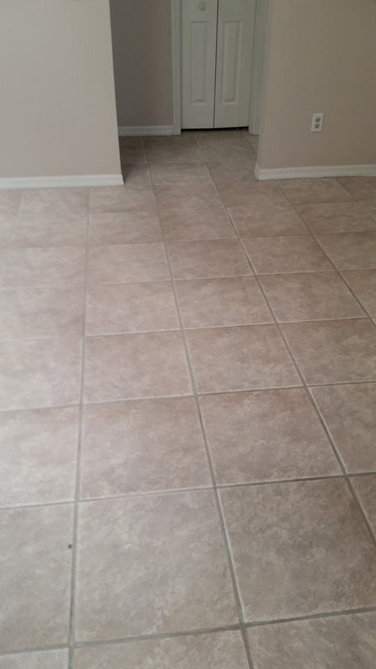 A tiled floor in an empty room in a house.