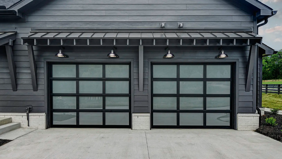 Modern single car all glass garage doors with frosted glass in black aluminum frames in Sarasota, FL