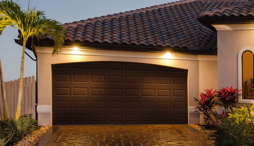 Steel garage door installation in Sarasota, FL with wood look paint finish