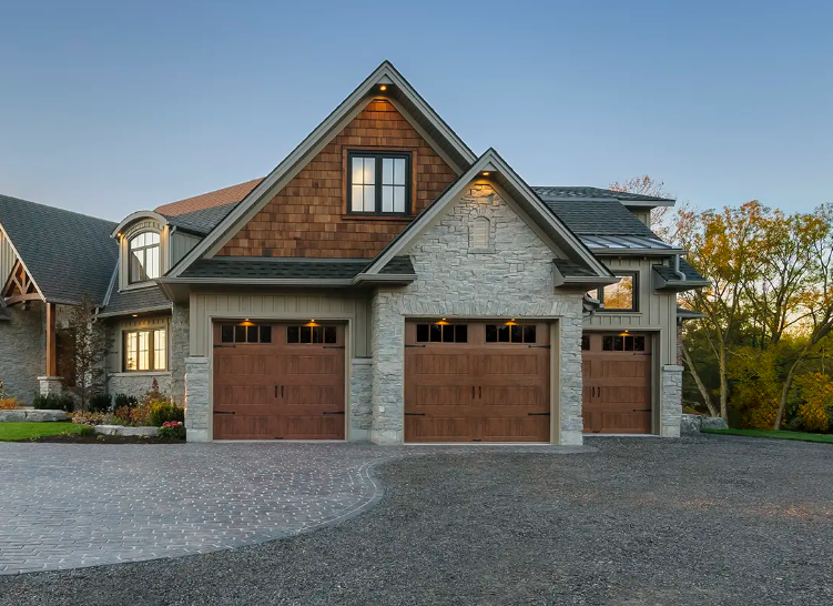Single car steel garage doors with window top sections and walnut wood look finish with decorative hardware in Sarasota, FL