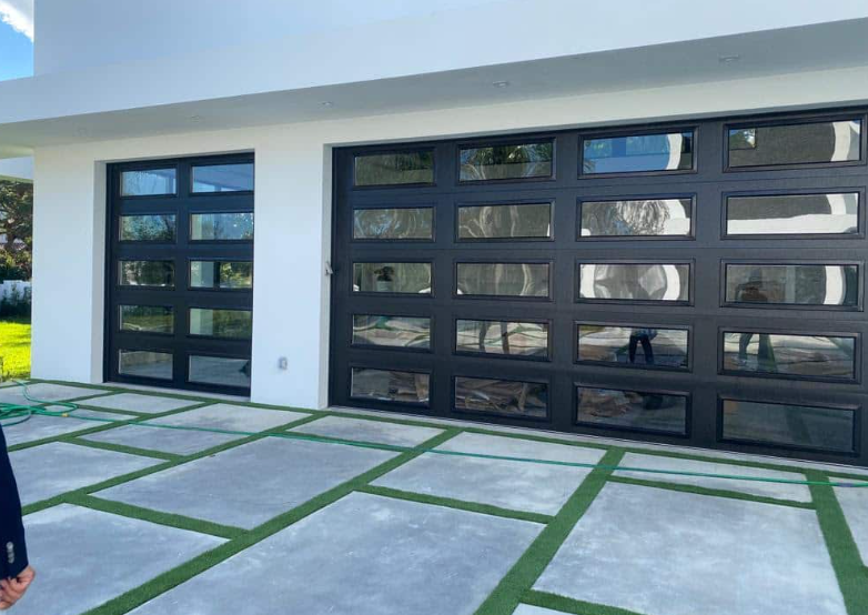 Glass 3 car garage doors with concrete and turf driveway in Bradenton, FL
