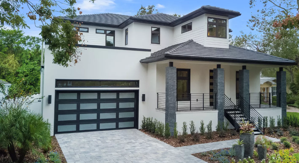 All glass steel garage door with black paint and frosted glass on a modern contemporary aesthetic house in Sarasota, FL