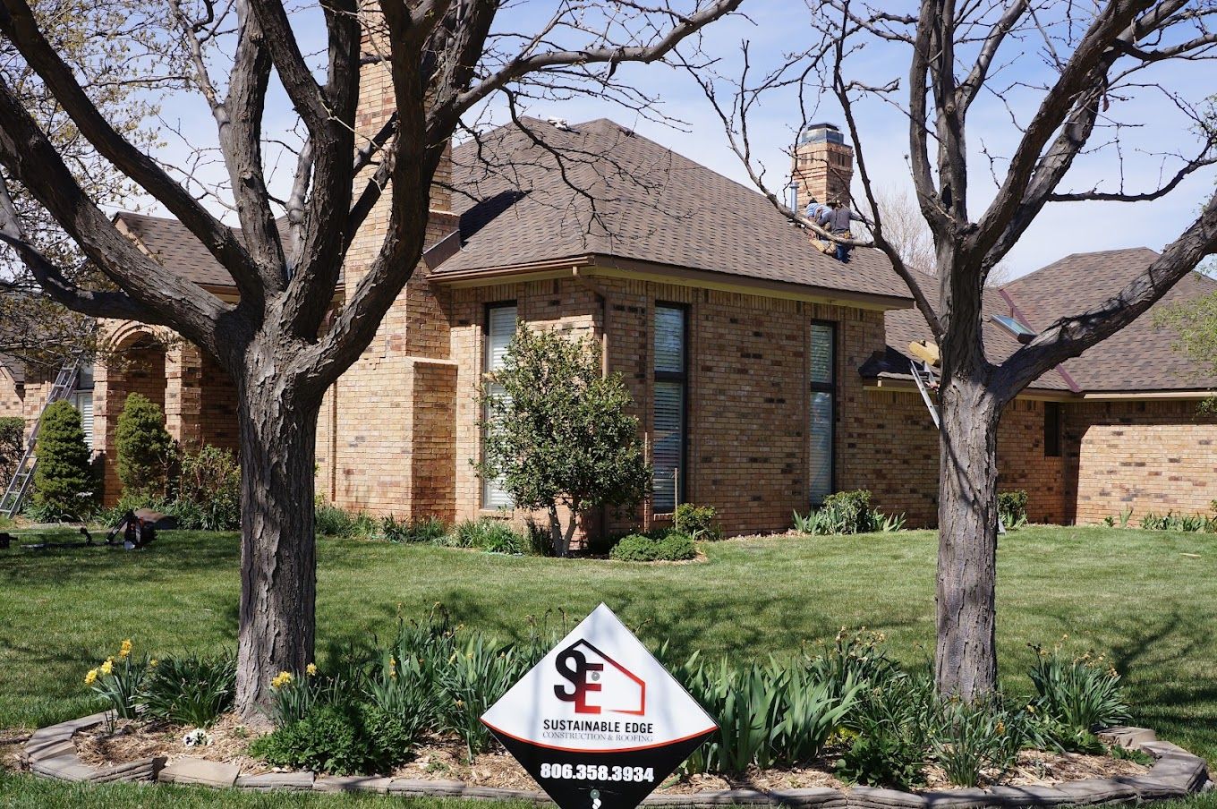 A house with a for sale sign in front of it