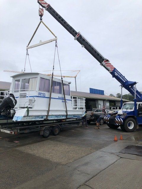A Crane is Lifting a Boat on a Trailer — CA Crane Hire in Forest Glen, QLD