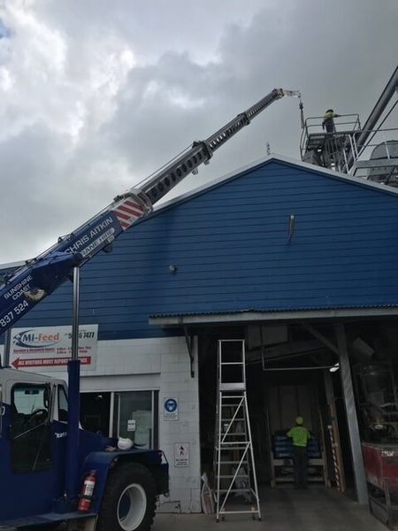 A Blue Truck is Parked in Front of a Blue Building — CA Crane Hire in Forest Glen, QLD