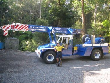 A Man Standing in Front of a Chris Aviation Truck — CA Crane Hire in Noosa, QLD