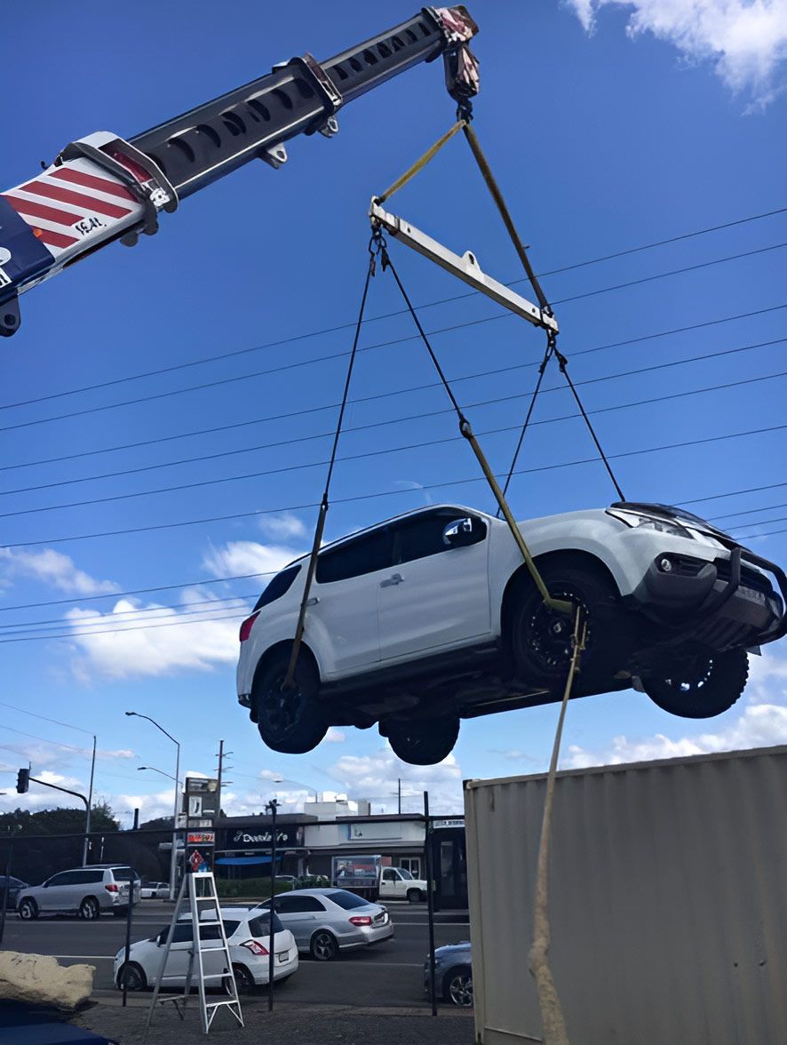 A White Car is Being Lifted by a Crane — CA Crane Hire in Noosa, QLD