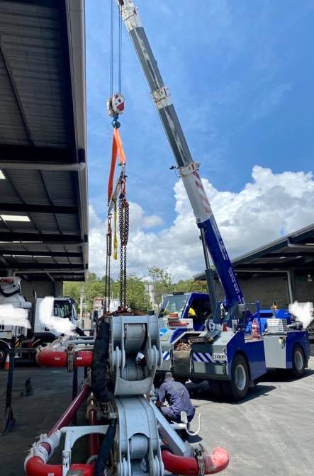 A Man is Working on a Crane in a Parking Lot — CA Crane Hire in Maroochydore, QLD