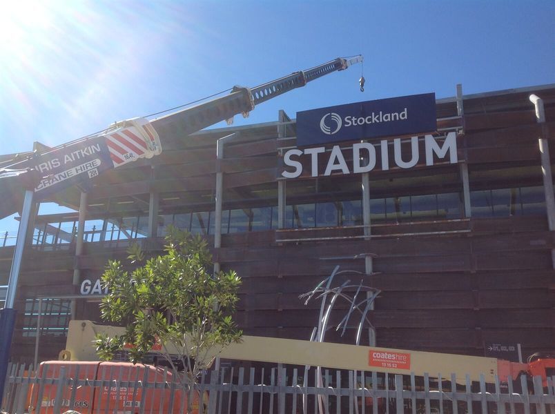 A Large Sign on the Side of a Building That Says Stadium — CA Crane Hire in Forest Glen, QLD