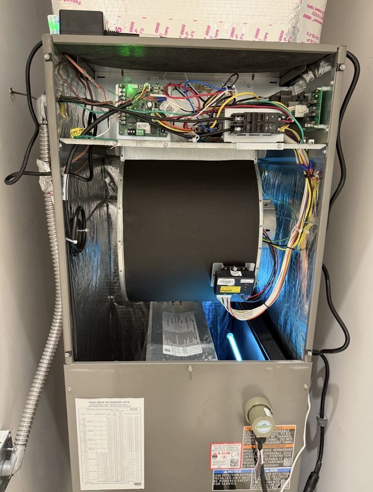 Open HVAC unit, revealing electrical components, ductwork, and a UV light.