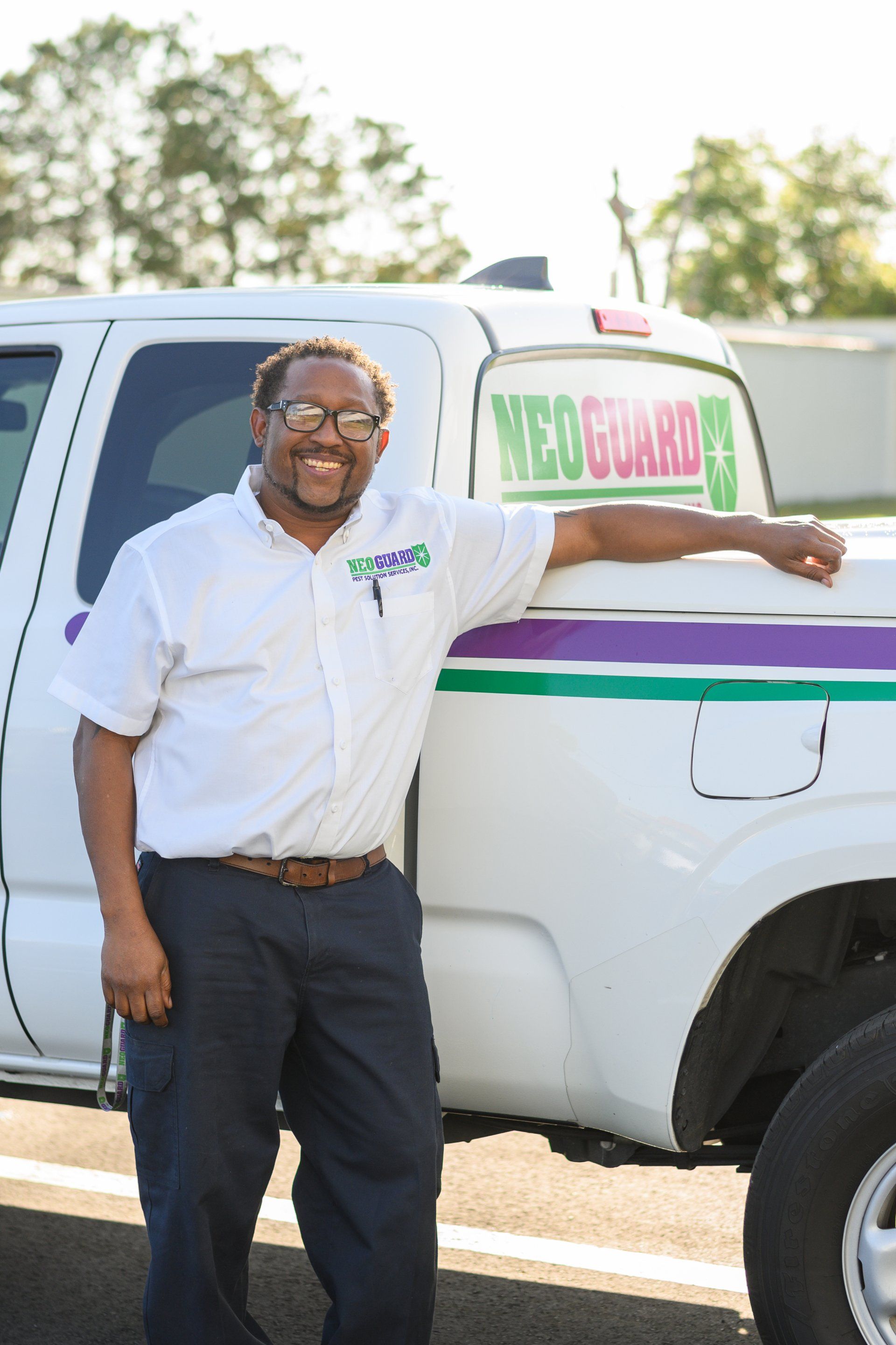 A man standing next to a neo guard truck